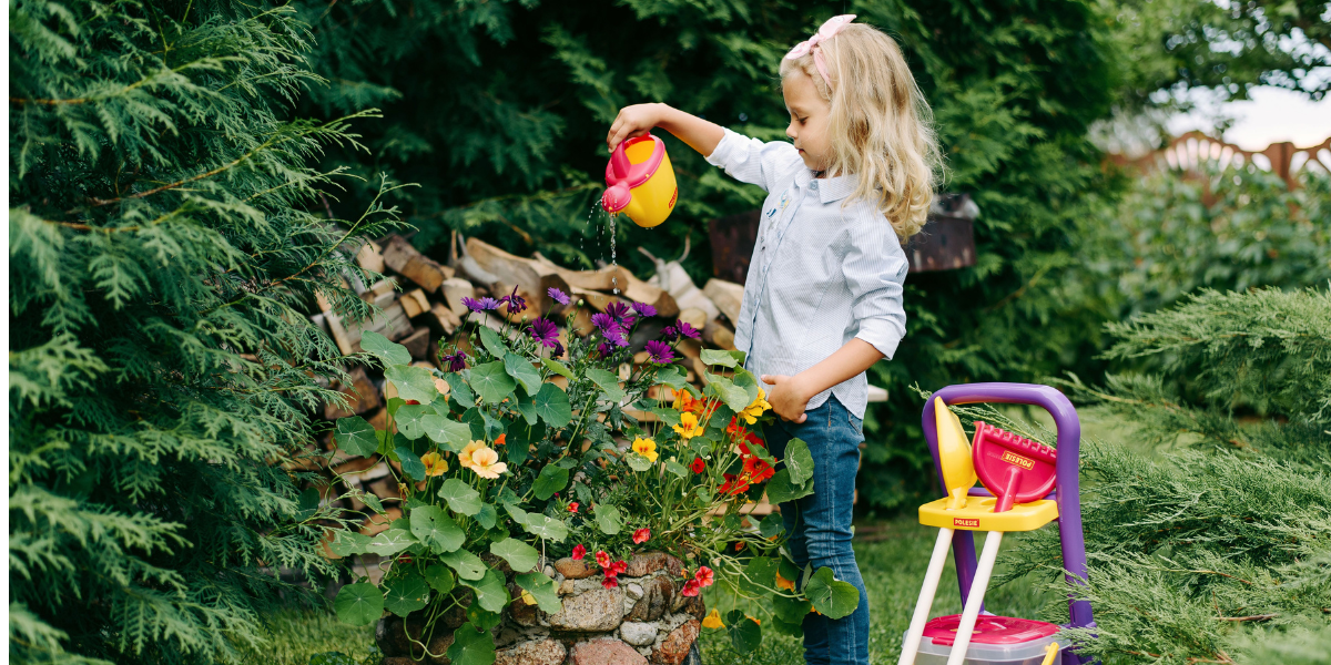 child watering in garden